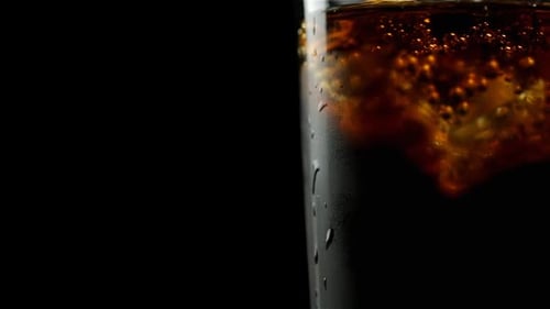 Refreshing Cola with Ice in Glass