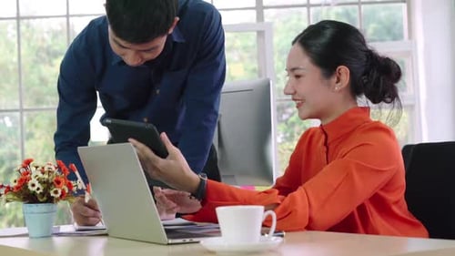 Two Business People Talk Project Strategy at Office