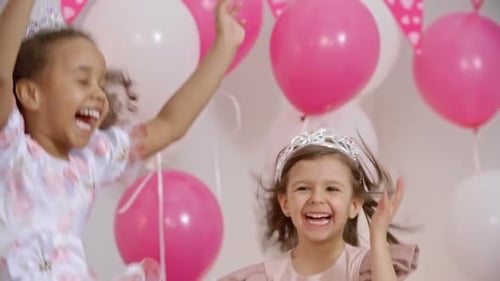 Happy Children Jumping with Gifts at Birthday Party