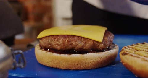 Making Cheese Burger. Chef Takes Cheese Preparing Burger. Close UP.
