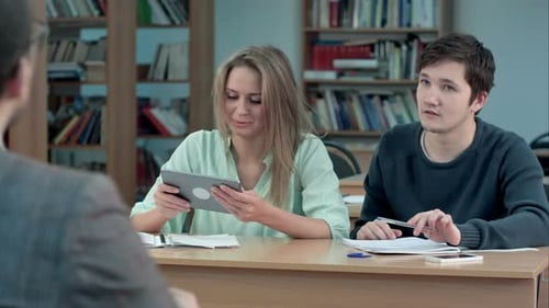 Students Typing on Tablet Computer in a Classroom