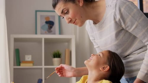 Child Painting with Mother at Home Art Project