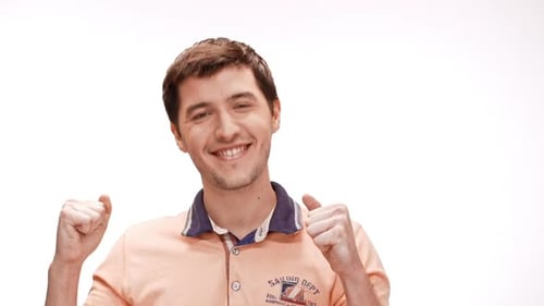 Man Smiles and Pumps Fists on White Background