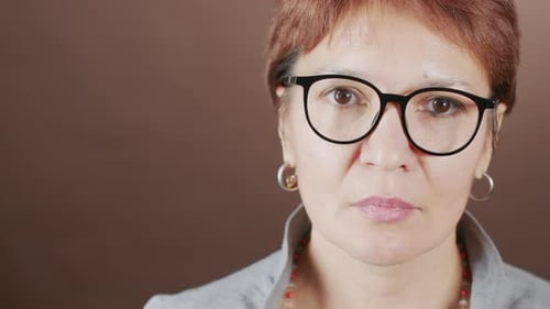 Close Up Portrait of Sad Mature Woman in Eyeglasses