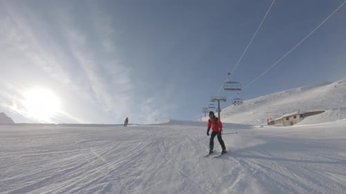 Man skiing on snowy slope at ski resort in the mountains
