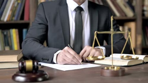 Close Up Shoot of Judge Hand Signing Document in Court Room