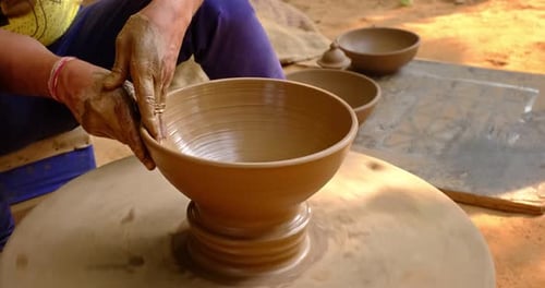 Hands Shaping Clay Bowl on Pottery Wheel