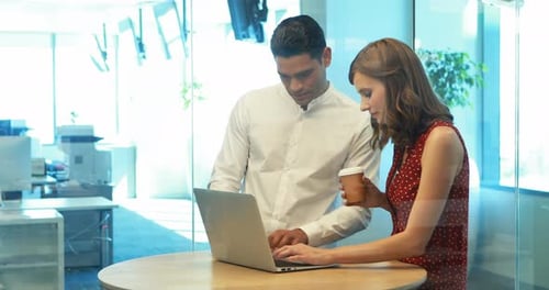 Teamwork in Modern Office: Man and Woman Collaborating