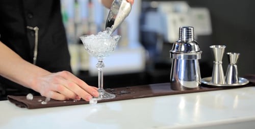 Bartender Preparing a Cocktail at a Bar