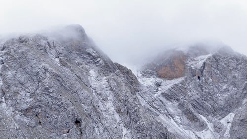 Snow-Dusted Mountain Peaks in Overcast Winter Scene
