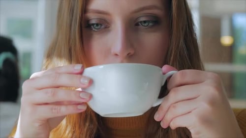 Closeup Portrait of Happy Pretty Young Woman in Cafe, Girl Sitting Drinking Coffee, Enjoying Coffee