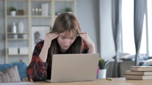 Stressed Woman Using Laptop Computer at Home