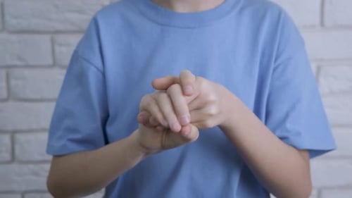 Child Uses Hand Sanitizer for Personal Hygiene