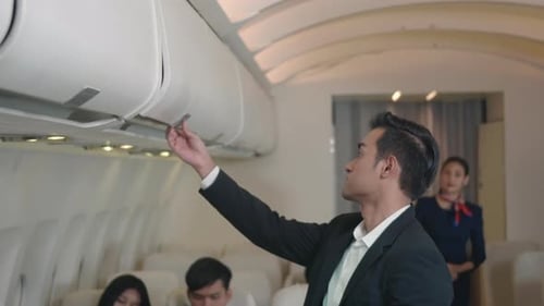 Man Getting Help with Luggage on Airplane