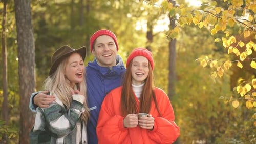 Caucasian Friends Look at Photos They Took in Forest