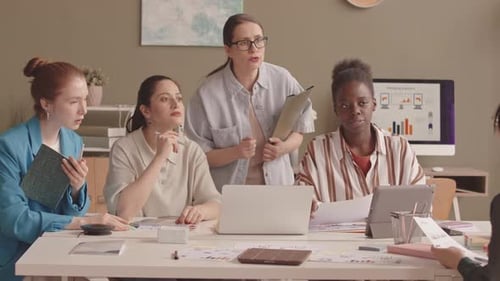Diverse Businesswomen Discussing Project Plan on Laptop