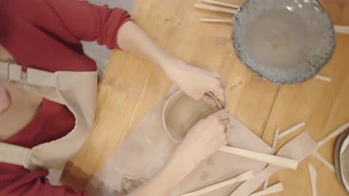 Ceramic Artist Shaping Clay Bowl at Table