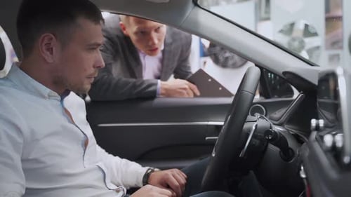 Man Talking To the Salesman at the Car Dealership While Choosing a New Auto Communication Positivity