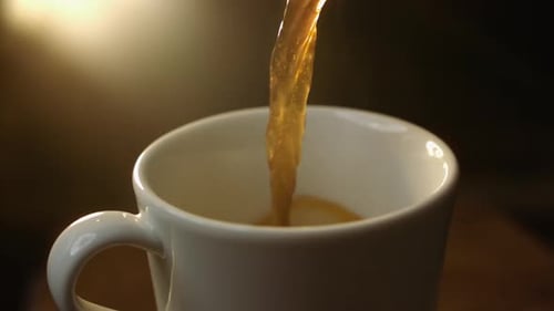 Coffee Pours into Mug in Cozy Close-Up