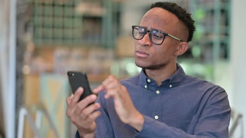 Young Adult Using Mobile Phone in Urban Setting