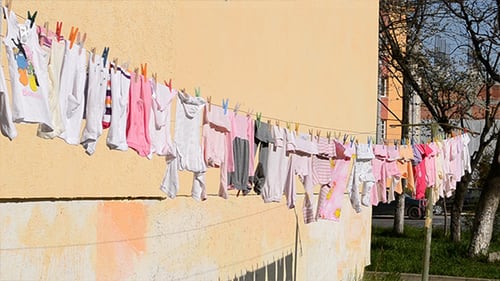 Infant Laundry Drying on Clothesline, Sunny Day