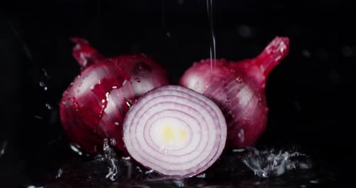 Red Onions Sliced and Whole Getting Water Droplets