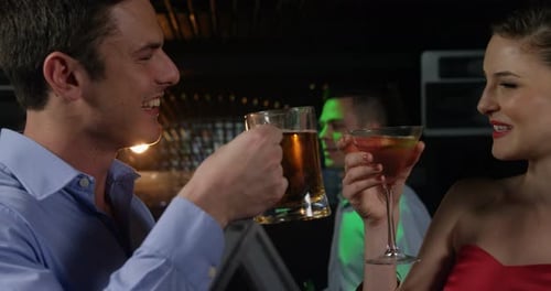 Man and Woman Enjoying Drinks at Bar