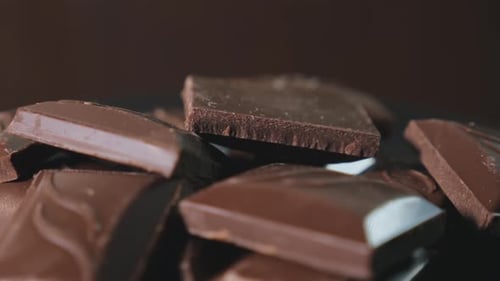Pieces of Delicious Dark Milk Chocolate Rotating