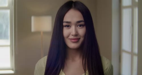 Smiling Asian Young Woman Looking to Camera on Home Office with Happy Emotion Enjoying Successful