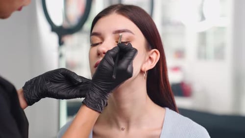 Eyebrow Shaping in Beauty Salon Close Up