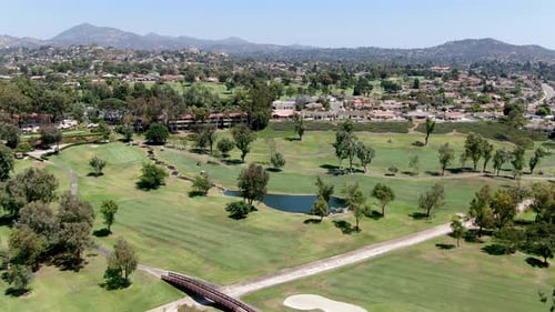 Aerial View of Golf in Upscale Residential Neighborhood.
