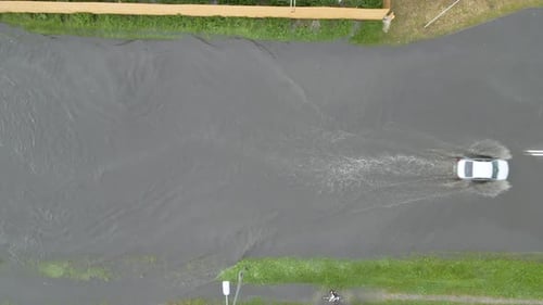 Aerial View of City Traffic with Cars Driving on Flooded Street After Heavy Rain