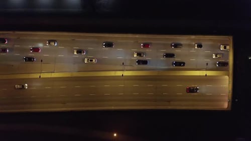 Aerial View of City at Night with Trafic and Cars Driving on the Freeway and Streets