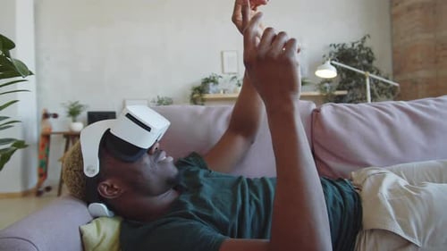 Young Adult Using VR Headset on Couch