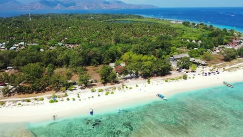 beautiful aerial panorama of the tropical island with palms and white sand beach, boats floating in