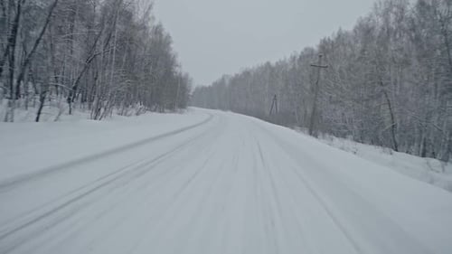 Driving Along Snowbound Rural Road
