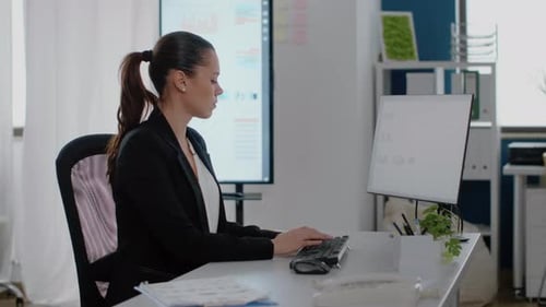Woman Typing at Computer in Modern Office