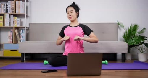 Woman Does Yoga Warmup at Home