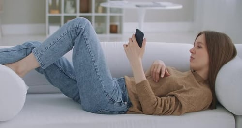 Woman Relaxing on Couch Talking on Phone