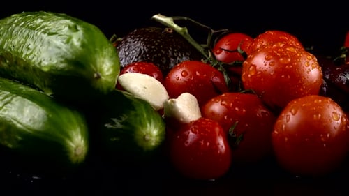 Fresh Vegetables with Water Droplets on Black Background
