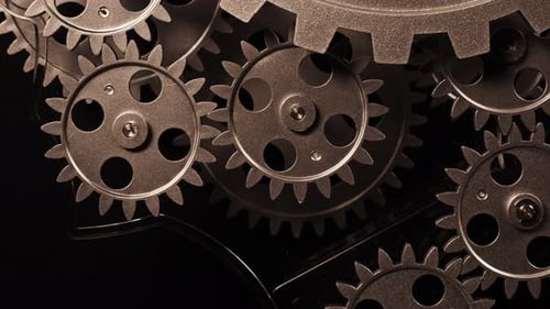 Rotating Metal Gears in Dark Lighting