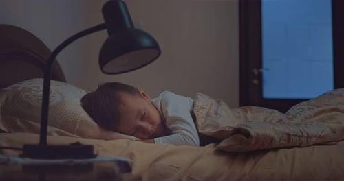 Young Child Sleeps Peacefully in Bed at Night