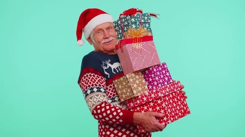 Festive Senior Man Holding Christmas Gifts and Smiling
