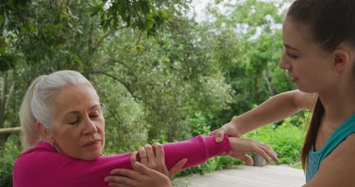 Senior woman exercising in a garden