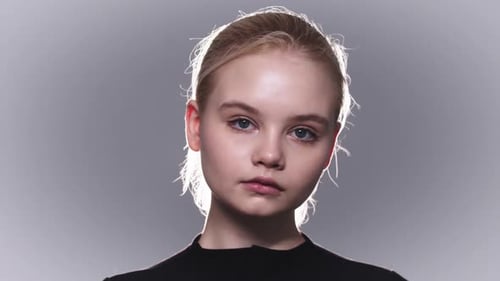 Blonde Woman with Blue Eyes Looks at Camera