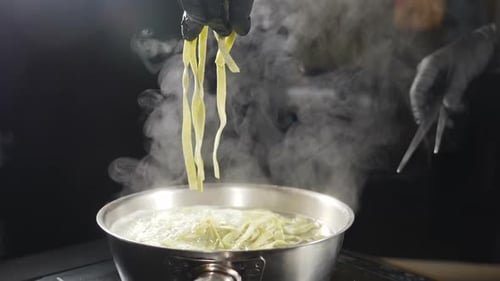 Chef Adds Pasta to Boiling Water in Pan