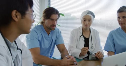 Medical Professionals Collaborate at Hospital Meeting
