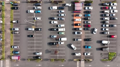 Aerial View of Many Colorful Cars Parked on Parking Lot with Lines and Markings for Parking Places