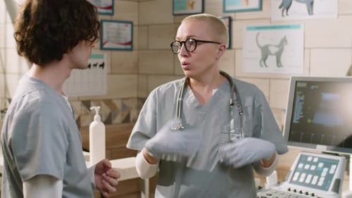 Female Vet Speaking with Colleague in Clinic