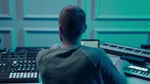 Music production studio. Producer. Man working in the recording studio with computer and mixer